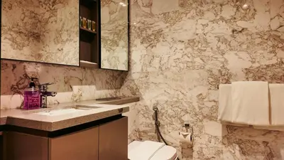 a bathroom with a toilet and a sink and a mirror at Eaton Residence KLCC - J Home in Kuala Lumpur