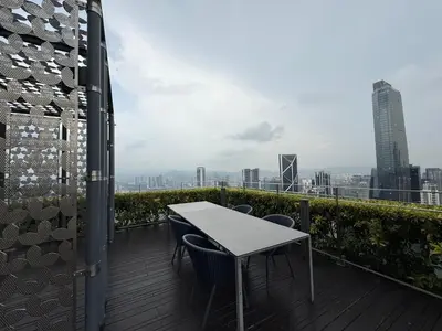 a table and chairs on a balcony with a city skyline at Star Residences in Kuala Lumpur