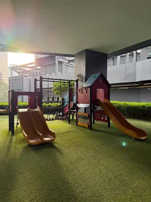 a playground with two slides in a building at Star Residence KLCC By Nexus 72 in Kuala Lumpur