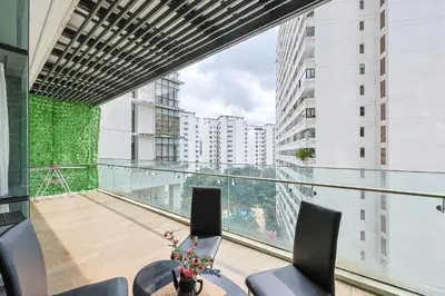 a balcony with a table and chairs and a large window at The Elements Ampang by Greenhome in Kuala Lumpur