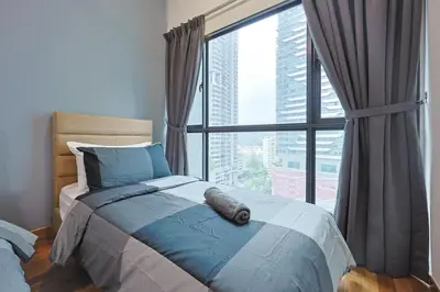 a bedroom with a bed with a large window at Reizz Residence by Greenhome in Kuala Lumpur