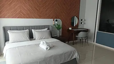 a bedroom with a bed with a white towel on it at Dorsett Residence by 