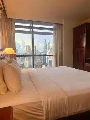a bedroom with a large bed and a large window at Times square by Willow Trip in Kuala Lumpur