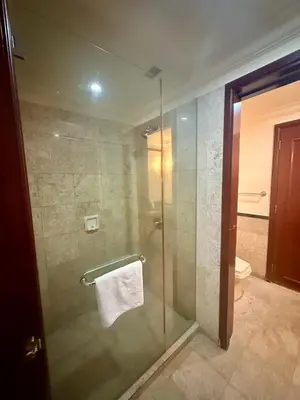 a glass shower in a bathroom with a toilet at Times square by Willow Trip in Kuala Lumpur