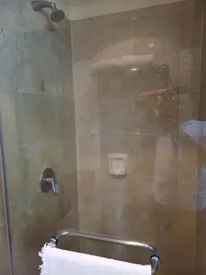 a shower with a glass door with a towel at KL Advice Suite At Times Square in Kuala Lumpur