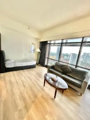 a living room with a couch and a bed and a table at Sunrise Residence At Berjaya Times Square AR in Kuala Lumpur