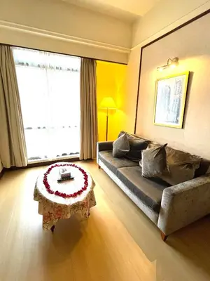 a living room with a couch and a coffee table at Sunrise Residence At Berjaya Times Square AR in Kuala Lumpur