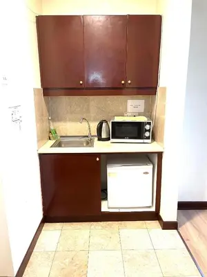 a small kitchen with a sink and a microwave at Sunrise Residence At Berjaya Times Square AR in Kuala Lumpur