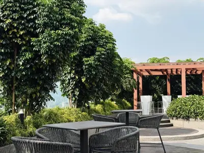 a patio with tables and chairs and a gazebo at Majestic Suites KLCC by KLIQ in Kuala Lumpur