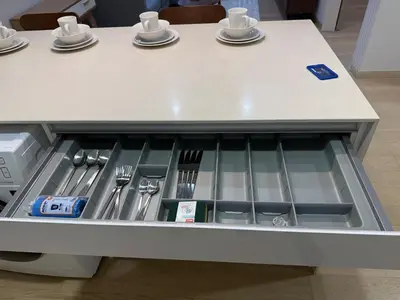 a table with a drawer with utensils in it at KL Star Residance by Nexus 52 in Kuala Lumpur
