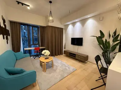 a living room with a blue couch and a table at KL Star Residance by Nexus 52 in Kuala Lumpur