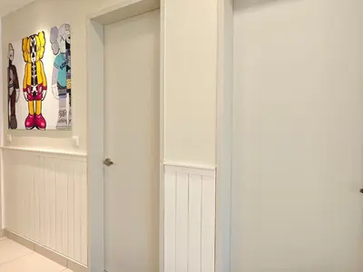 a room with a closet with a door at TRION The 107 Family Suites POOL VIEW in Kuala Lumpur