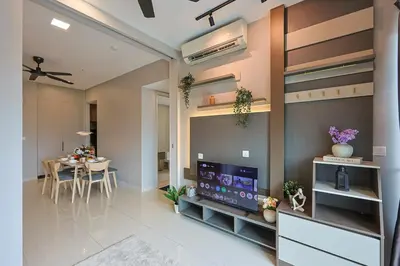 a living room with a dining room table and a television at Elegant Skyline Suite Datum Jelatek near KLCC in Kampong Datok Keramat