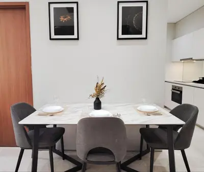a kitchen with a white table and chairs at KLCC Luxe High speed wifi 2BR Residence in Kuala Lumpur