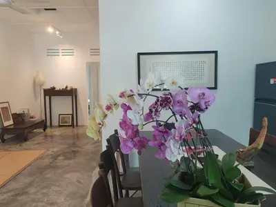 a vase filled with purple and white flowers in a room at Zen Retreat KL in Kuala Lumpur