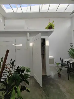 a white room with a table and chairs and a ceiling at Zen Retreat KL in Kuala Lumpur