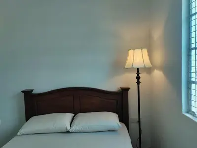 a bedroom with a bed with a lamp next to it at Zen Retreat KL in Kuala Lumpur