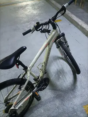 a bike is parked on a street with itsearch at Cozy Hostel City Central in Kuala Lumpur