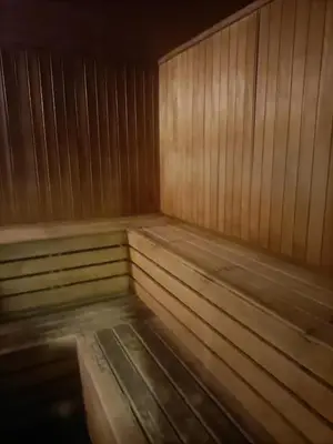 a empty sauna with wood paneled walls and benches at Cozy Hostel City Central in Kuala Lumpur