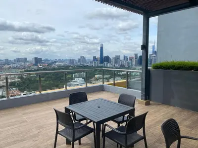 a table and chairs on a balcony with a view of a city at KL City, Neu Suites 2Bedroom 2Bathroom in Kuala Lumpur