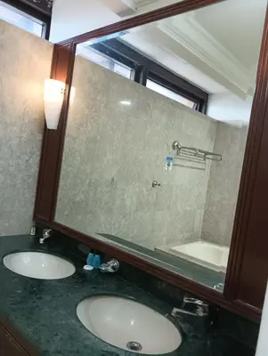 a bathroom with two sinks and a large mirror at Royal Service Suite At Berjaya Times Square in Kuala Lumpur