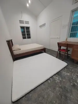 a white room with a bed and a desk at Zen 1 Room KL in Kuala Lumpur