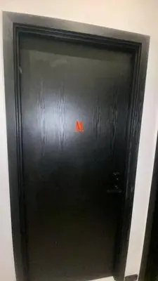 a black door with a red sign on it at Cozy, Mini Studio Apartment at Neu Suites by OKBnB in Kuala Lumpur