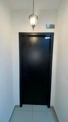 a black door in a room with a light at Cozy, Mini Studio Apartment at Neu Suites by OKBnB in Kuala Lumpur