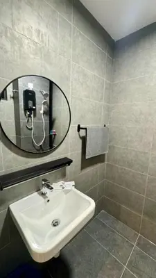 a bathroom with a sink and a mirror at Cozy, Mini Studio Apartment at Neu Suites by OKBnB in Kuala Lumpur