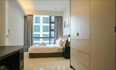 a bedroom with a bed and a large window at park view one bedroom apartment klcc in Kuala Lumpur