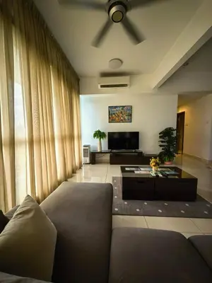 a living room with a couch and a television at park view one bedroom apartment klcc in Kuala Lumpur