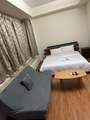 a bedroom with a bed and a coffee table at park view one bedroom apartment klcc in Kuala Lumpur