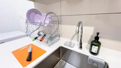 a kitchen counter top with a sink and a sink at Majestic Residence sky pool 10mins to KLCC By Light House in Kuala Lumpur