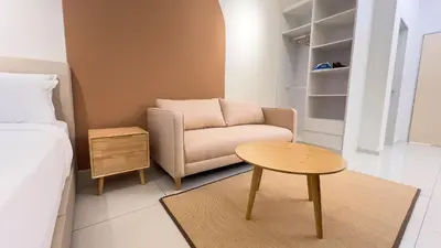 a small living room with a couch and a table at Majestic Residence sky pool 10mins to KLCC By Light House in Kuala Lumpur