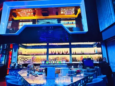 a bar with a large wall of liquor bottles at PLATINUM Suites KLCC at BBS in Kuala Lumpur