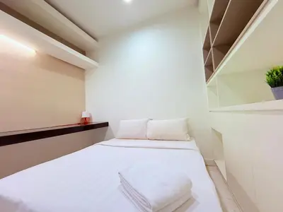 a small room with a bed with white sheets at PLATINUM Suites KLCC at BBS in Kuala Lumpur