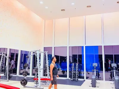 a man walking through a gym at PLATINUM Suites KLCC at BBS in Kuala Lumpur