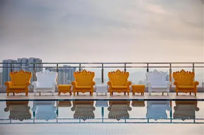 a group of chairs sitting on top of a building at Dorsett Hartamas Mont Kiara Kuala Lumpur Mitec by innfinitystay in Kuala Lumpur
