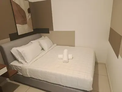 a bed with two white towels on top of it at Kuala Lumpur Suites Majestic Sky Pool in Kuala Lumpur