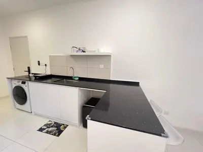 a kitchen with a black counter top and a sink at Kuala Lumpur Suites Majestic Sky Pool in Kuala Lumpur