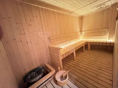 an empty sauna with a bench and a trash can at Kuala Lumpur Suites Majestic Sky Pool in Kuala Lumpur