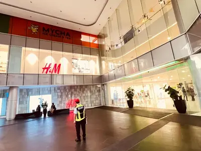 a man is standing in a shopping mall at Kuala Lumpur Suites Majestic Sky Pool in Kuala Lumpur