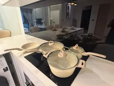 three pots and pans sitting on a stove in a kitchen at KL Star Residance KLCC by Nexus in Kuala Lumpur