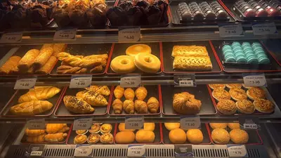 a display case filled with lots of different types of donuts at KL Star Residance KLCC by Nexus in Kuala Lumpur