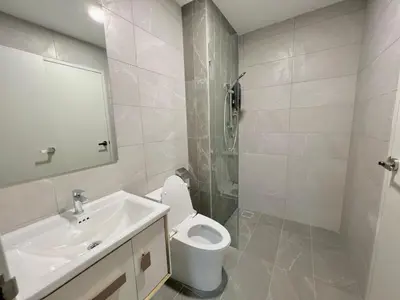 a white bathroom with a sink and a toilet at Majestic Residence Kuala Lumpur in Kuala Lumpur