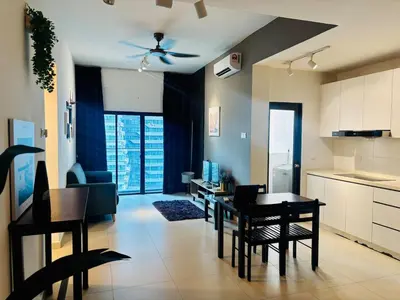 a kitchen and living room with a table and chairs at Reizz Residence by Willow Trip in Kuala Lumpur