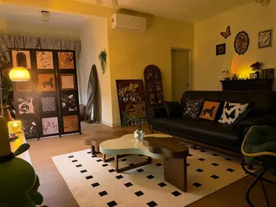 a living room with a black couch and a table at Cheras KL Velocity Mall VR3 8pax MRT Maluri NAN JING STREET 焦赖吉隆坡 步行1分钟到 双威伟乐城&南京街 可容8人 in Kuala Lumpur