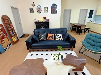 a living room with a blue couch and a table at Cheras KL Velocity Mall VR3 8pax MRT Maluri NAN JING STREET 焦赖吉隆坡 步行1分钟到 双威伟乐城&南京街 可容8人 in Kuala Lumpur