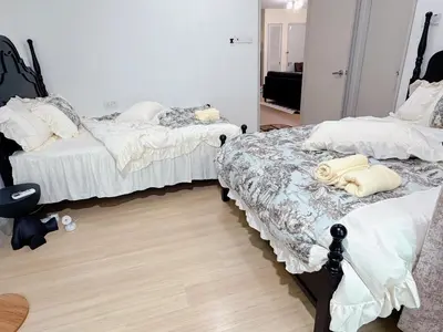 a bedroom with two beds and a mirror at Cheras KL Velocity Mall VR3 8pax MRT Maluri NAN JING STREET 焦赖吉隆坡 步行1分钟到 双威伟乐城&南京街 可容8人 in Kuala Lumpur