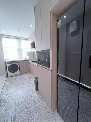 a small kitchen with a sink and a refrigerator at Parkview Serviced Apartment in Kuala Lumpur